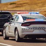 American Highway State Trooper Pulling Over Vehicle For Speeding Reason.