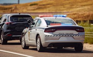 American Highway State Trooper Pulling Over Vehicle For Speeding Reason.